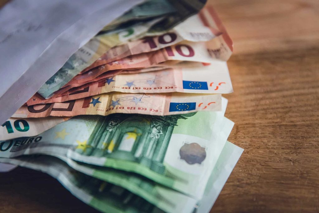Euro banknotes on a table.