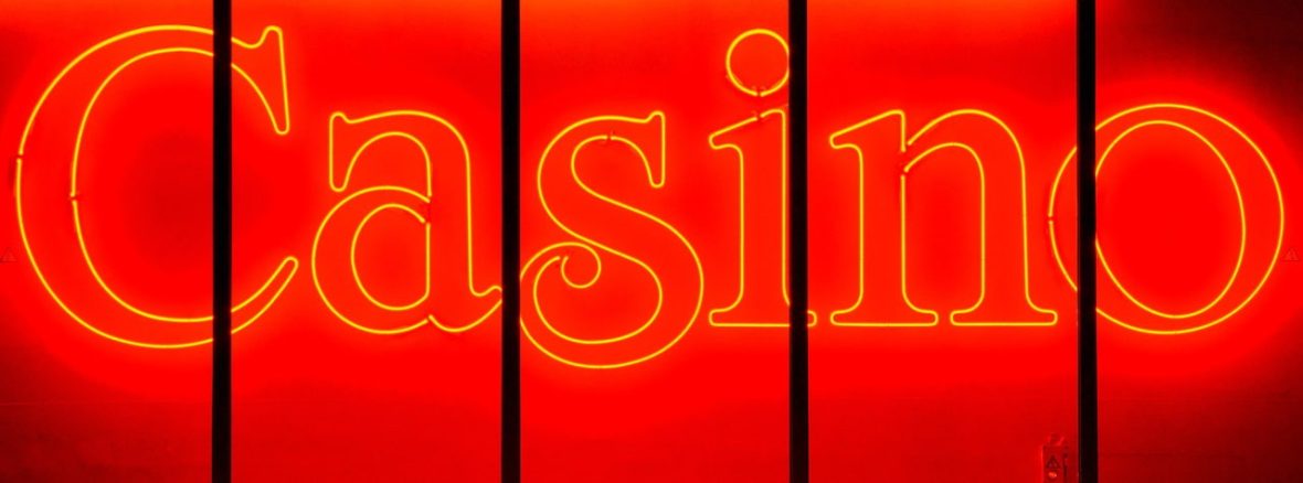 Neon red Casino sign glowing brightly against a dark background